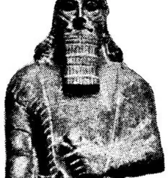Statue of Ashurnasirpal II shown as a full-length bearded figure in patterned garments, holding a dagger across the chest.