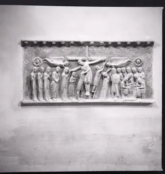 Marble relief of the Descent from the Cross with a crowded scene of figures surrounding the lowered body of Christ.