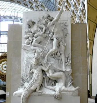The Nubians relief sculpture showing figures in a struggle with a spear, a seated woman and infant, and a rearing crocodile.