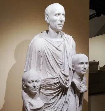Togatus Barberini, a white marble statue of a man in a toga holding two portrait busts.