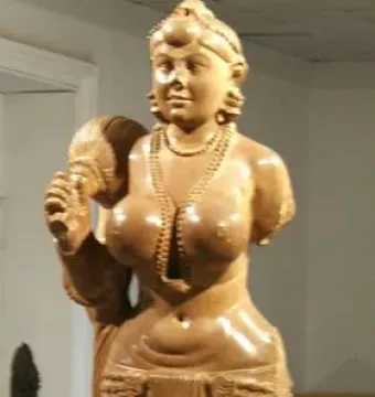 Didarganj Yakshi statue with a crowned female figure holding a fly-whisk and wearing necklaces and a draped skirt