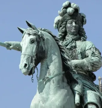 Upper portion of the Equestrian Statue of Louis XIV, showing the rider with a feathered hat and baton on horseback.