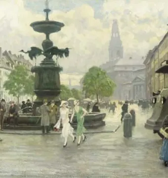 Stork Fountain in a busy city square with a dark basin and three bird figures around the central column.
