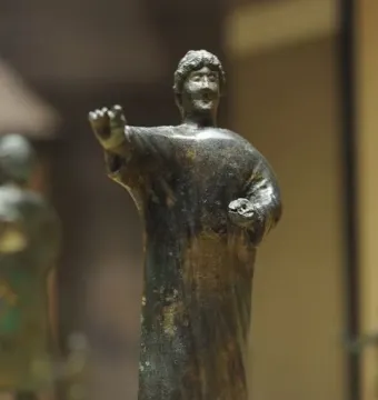 Bronze statuette of the Orator from the Neuvy-en-Sullias Hoard, showing a standing male figure in a tunic with one arm extended and a small object in the other hand.