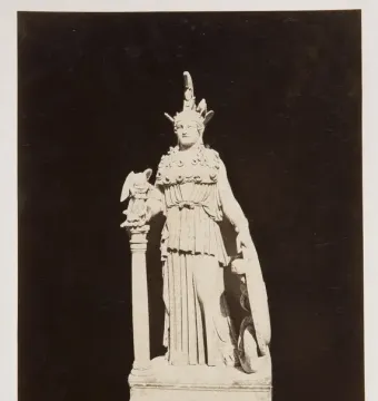 Varvakeion Athena statue holding a small winged figure, with a shield beside her.