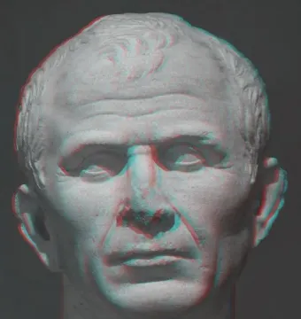 Classical marble bust of Julius Caesar with a red-cyan anaglyph effect against a dark gray background.