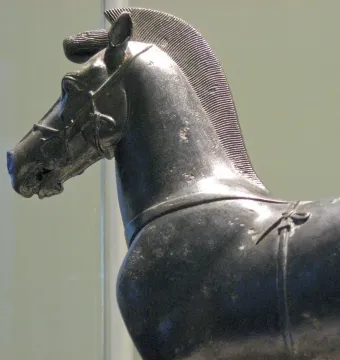 Bronze horse sculpture from a quadriga, shown in profile with a ridged mane and harness details.