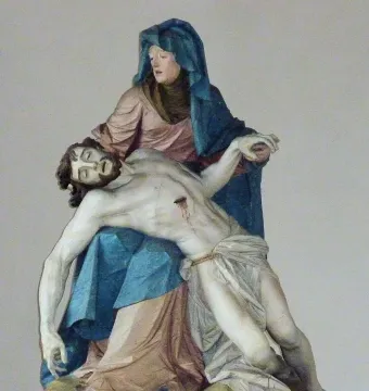 Nenningen Pietà showing a robed woman cradling the lifeless body of a bearded man across her lap.