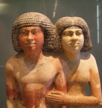 Raherka and Meresankh painted double statue of a man and a woman standing side by side, with the woman’s arm around the man’s waist.