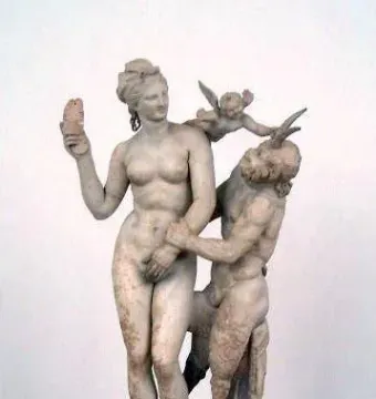 Aphrodite, Pan and Eros marble sculpture showing a nude woman holding up a sandal as Pan reaches toward her and a winged child pushes his head away.