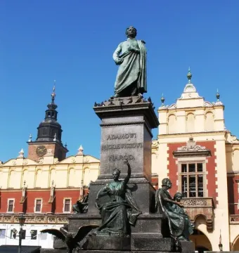 Adam Mickiewicz Monument with bronze figures and an eagle in Kraków’s main square