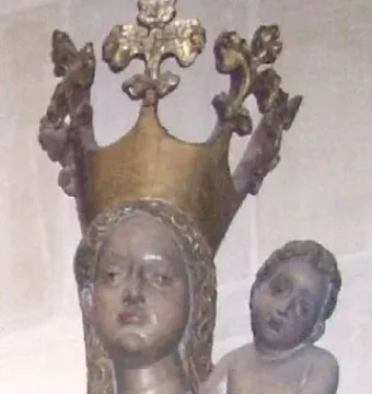 Inkpot Madonna showing a crowned woman in blue robes holding a child, who grips a small dark rounded object.