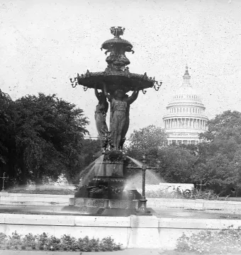 Bartholdi Fountain with robed female statues and the U.S. Capitol dome in the background.