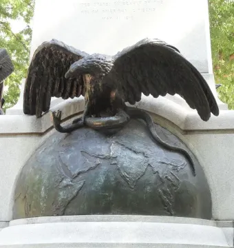 Tadeusz Kościuszko monument detail showing a bronze eagle with outstretched wings perched on a globe and gripping a snake.