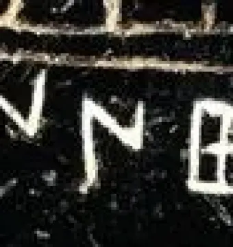 Etched alphabet inscription on a dark textured surface, likely from the Viterbo Rooster.