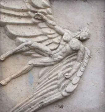 Relief detail of Flygarmonumentet showing a winged human figure in motion with outstretched arms and legs.