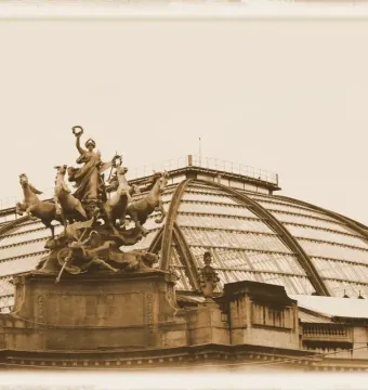 Immortality Overtaking Time sculpture silhouetted against the glass dome of the Grand Palais