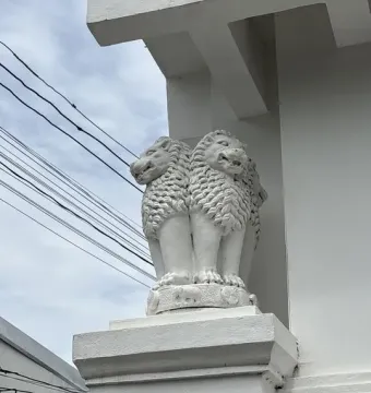 White Lion Capital of Ashoka sculpture with lions back-to-back on a pedestal and a carved circular base.