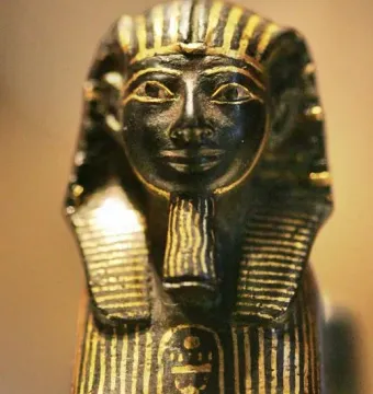 Thutmose III sphinx statuette with a pharaonic headdress, false beard, and gold-striped detailing.