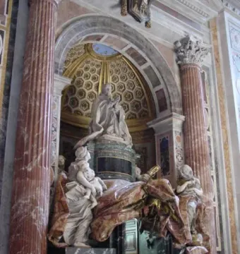 Tomb of Pope Alexander VII with a kneeling marble figure, gilded canopy, and draped allegorical sculptures