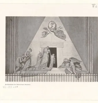 Cenotaph of Archduchess Maria Christina with a pyramid-shaped monument, a dark entrance, and sculpted figures around its base.