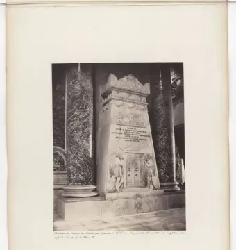 The Monument to the Royal Stuarts, a tall marble monument with inscriptions, relief carvings, and flanking sculpted figures inside an interior setting.