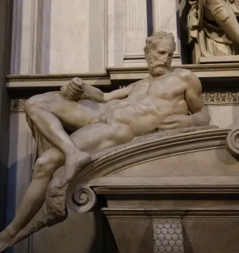 Reclining marble statue of Lorenzo II de Medici by Michelangelo, shown with a downward gaze and bent arm.