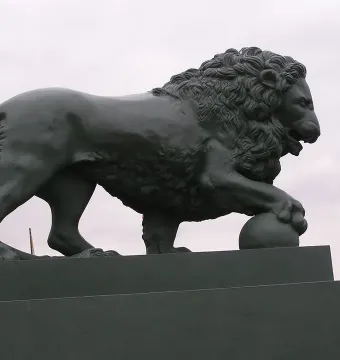 Lions at the Dvortsovaya Pier sculpture of a standing lion with a paw on a sphere.