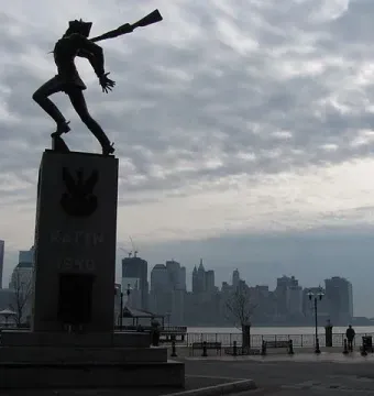 Katyń Memorial with a dark soldier-like figure on a tall stone pedestal marked KATYN 1940.