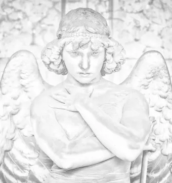 Monteverde Angel stone sculpture with feathered wings and crossed hands