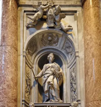 Tomb of Countess Matilda of Tuscany with a standing marble figure in an arched niche, flanked by carved putti and columns.