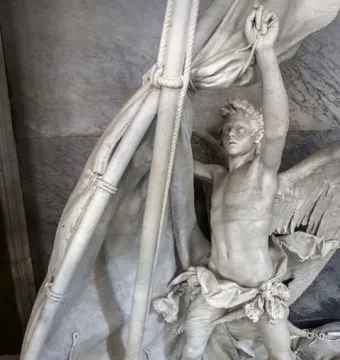 Angelo Nocchiero, a winged marble angel standing in a boat and holding ropes beside a mast and furled sails.
