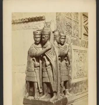 Portrait of the Four Tetrarchs sculpture beside an ornate stone building corner