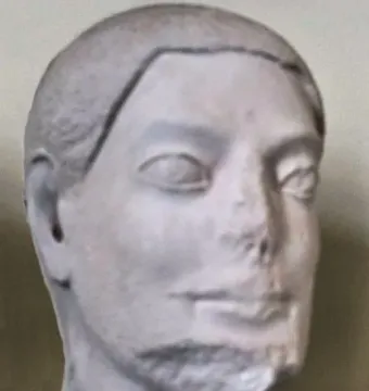Sabouroff Head, a light-colored sculptural male head with stylized eyes, a damaged nose and mouth, and short sculpted hair and beard.
