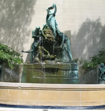 Fountain of the Great Lakes with bronze draped figures surrounding a cascading water vessel.