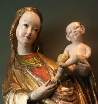 Beautiful Virgin Mary from Krużlowa, a crowned Madonna sculpture in golden robes holding a naked infant and a golden orb.