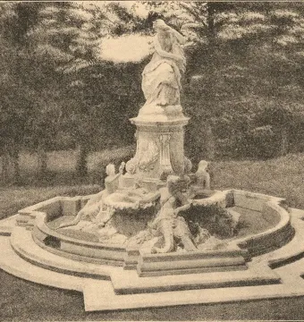 The Lorelei Fountain, a stone monument with a seated figure at the top and smaller carved figures around the base.