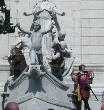 USS Maine National Monument with a camera crane and film crew around the stone sculpture