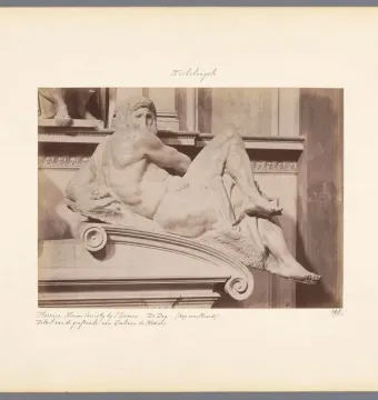 Michelangelo\'s Day sculpture on the tomb of Giuliano de\' Medici, shown in a sepia photograph from the back.