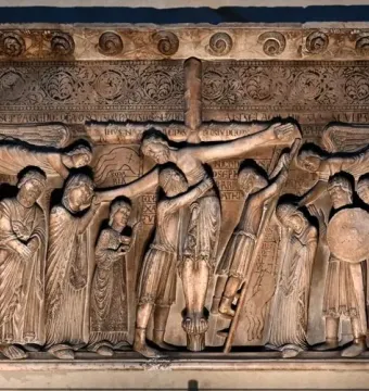 Stone relief of the Descent from the Cross with figures gathered around the lowered body of Christ.
