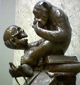 Monkey with a Skull sculpture showing a seated primate holding and gazing at a human skull
