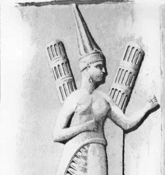 Yazılıkaya relief carving of a figure in profile wearing a tall headdress and pleated skirt, holding a staff.