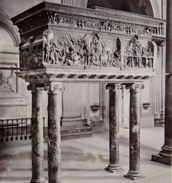 The Resurrection Pulpit by Donatello, a bronze pulpit with detailed relief scenes on four marble columns inside a church.