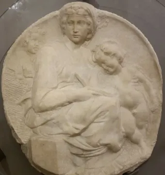 Pitti Tondo marble relief showing a seated woman with two children.