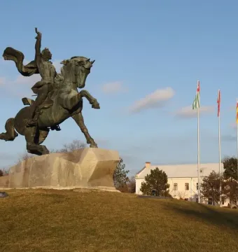 Suvorov Monument, a bronze equestrian statue of Alexander Suvorov on a stone base with flags and a building in the background.