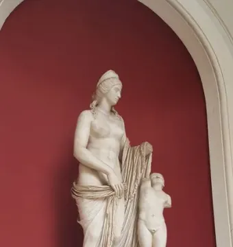 Venus Felix marble statue with a standing draped female figure beside a smaller nude figure with missing arms.