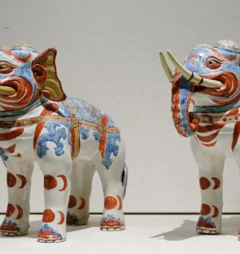 Pair of Kakiemon elephants with blue, red, and gold decorative patterns on white porcelain.