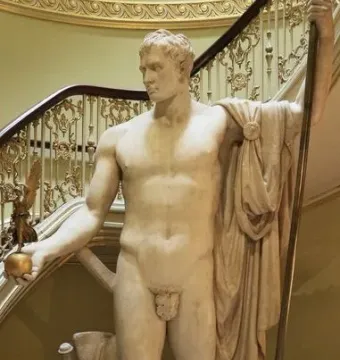 Napoleon as Mars the Peacemaker statue on a dark pedestal, showing a white marble nude figure holding a golden orb and staff.