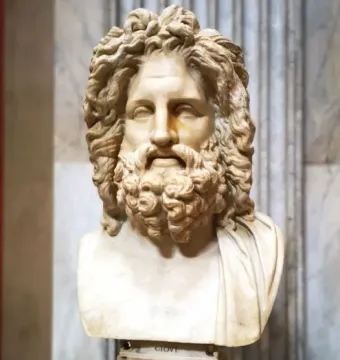 Zeus of Otricoli marble bust of a bearded man with long curly hair and draped shoulders on a carved pedestal