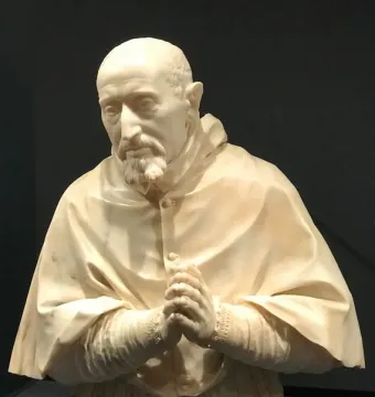 Marble bust of Cardinal Roberto Bellarmine showing a bearded man in a hooded robe with clasped hands.